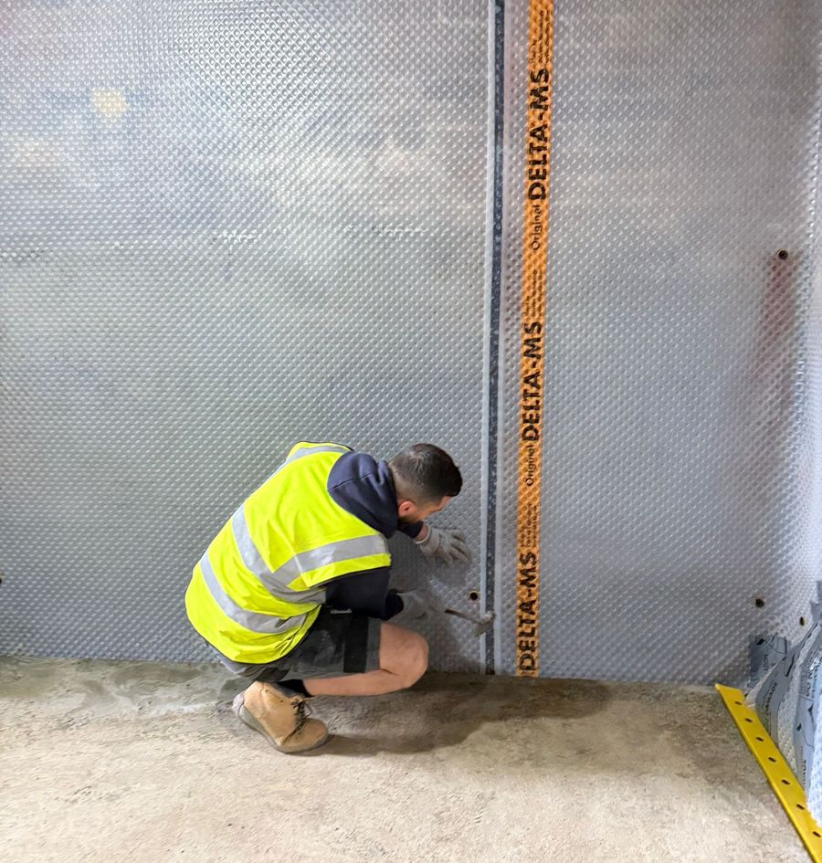 City Waterproofing technician fitting a damp proof membrane