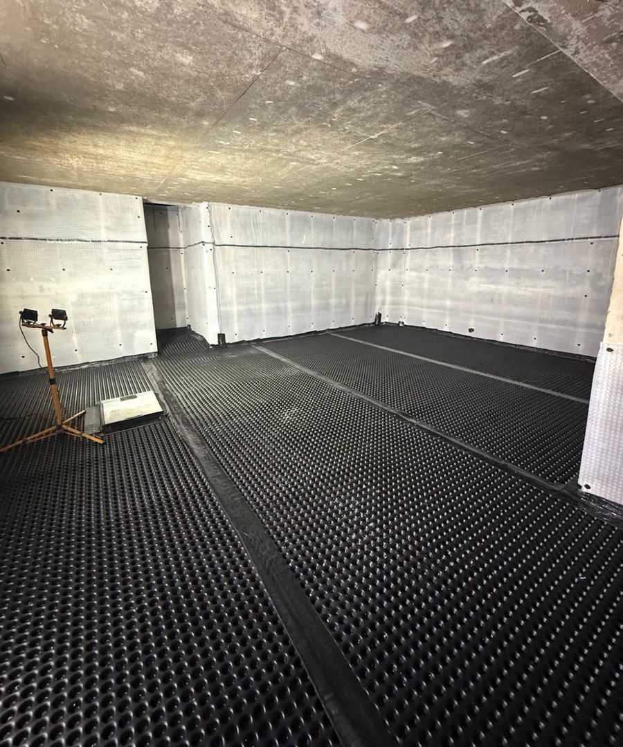 Cavity drain membrane system installed across a London basement